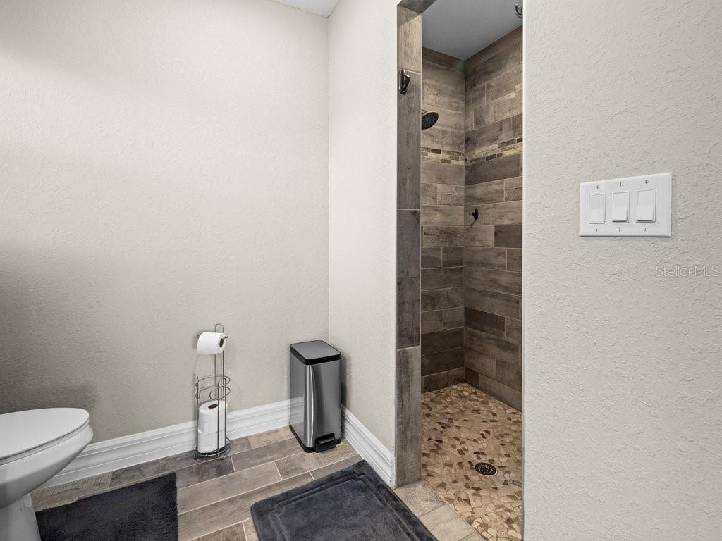 8221 Agate Street Port Charlotte, FL 33981 - Photo 32 of 50 a bathroom with a toilet and shower