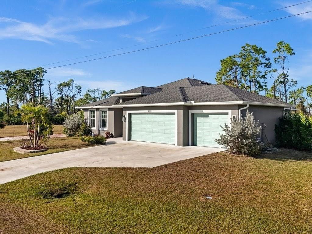8221 Agate Street Port Charlotte, FL 33981 - Photo 50 of 50 a front view of a house with a yard and garage