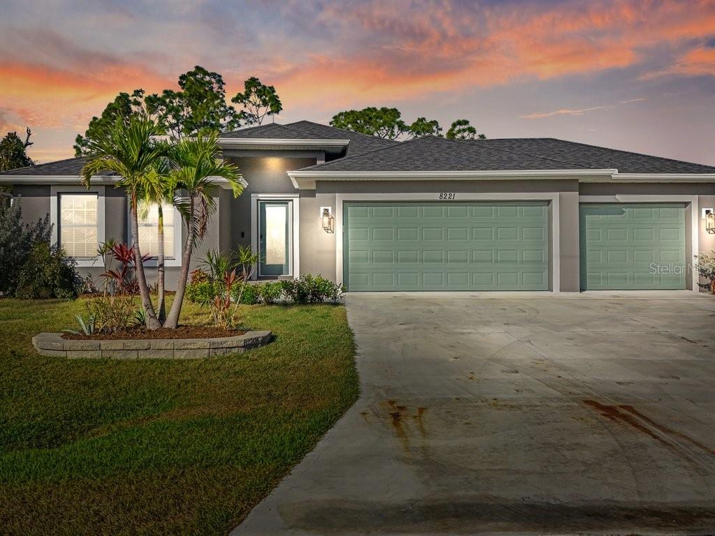 8221 Agate Street Port Charlotte, FL 33981 - Photo 5 of 50 a front view of a house with a yard