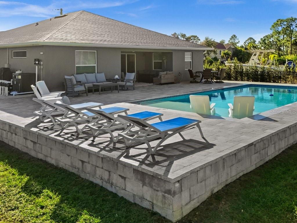 8221 Agate Street Port Charlotte, FL 33981 - Photo 9 of 50 a view of a house with swimming pool and sitting area