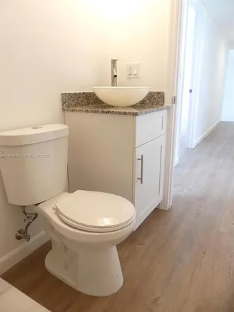 a white toilet sitting next to a bath tub and a shower