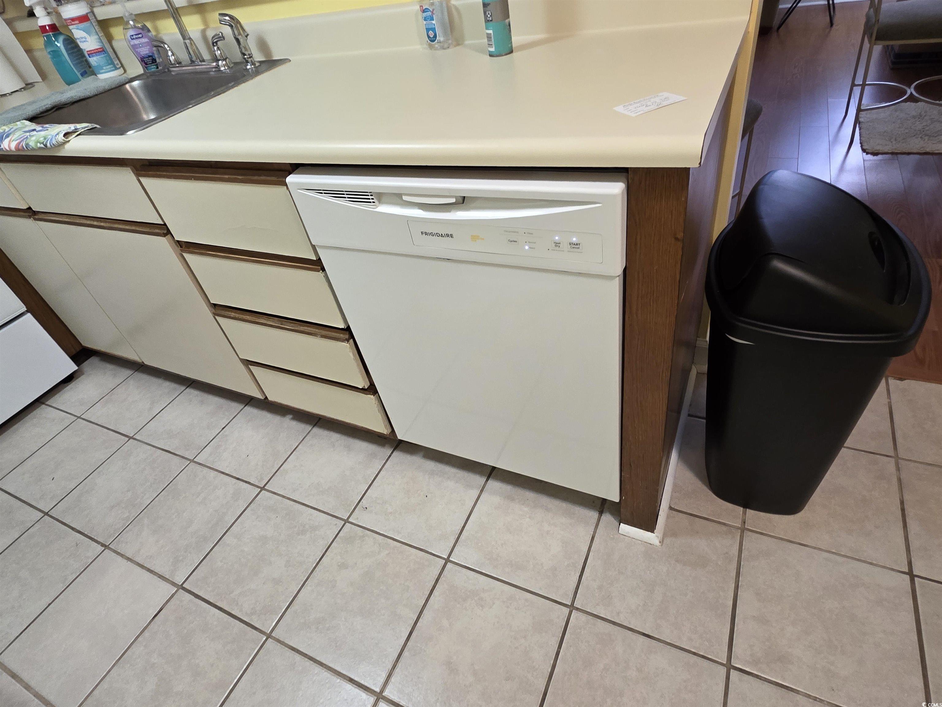 5905 Highway 17 South, Unit 6105 Myrtle Beach, SC 29575 - Photo 5 of 25 Kitchen with dishwasher, light countertops, light tile patterned floors, and white cabinets
