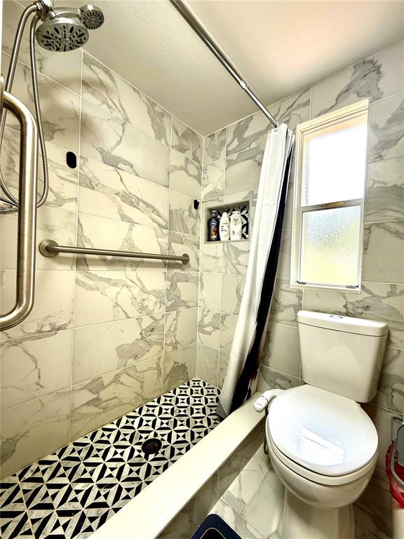 208 Ashley Street Hawthorne, FL 32640 - Photo 15 of 32 a bathroom with a sink and a shower