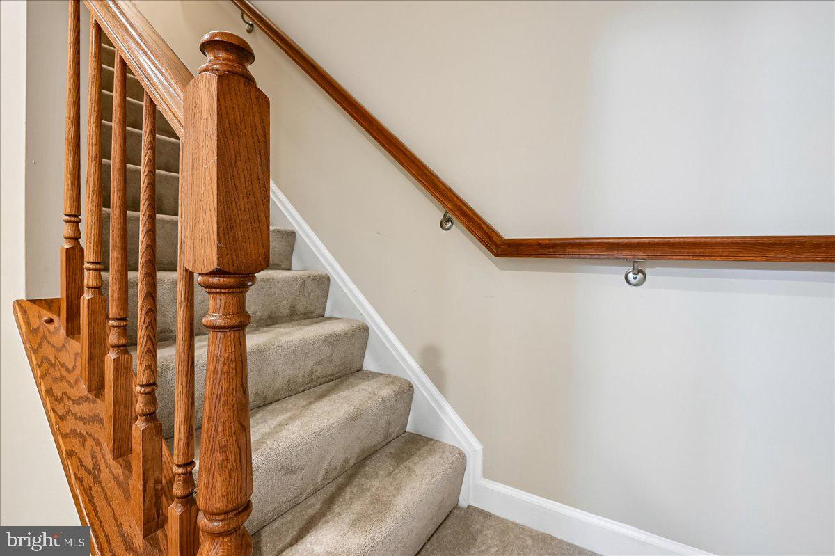 603 Queenstown Road Severn, MD 21144 - Photo 47 of 85 Elegant staircase with wooden railing.