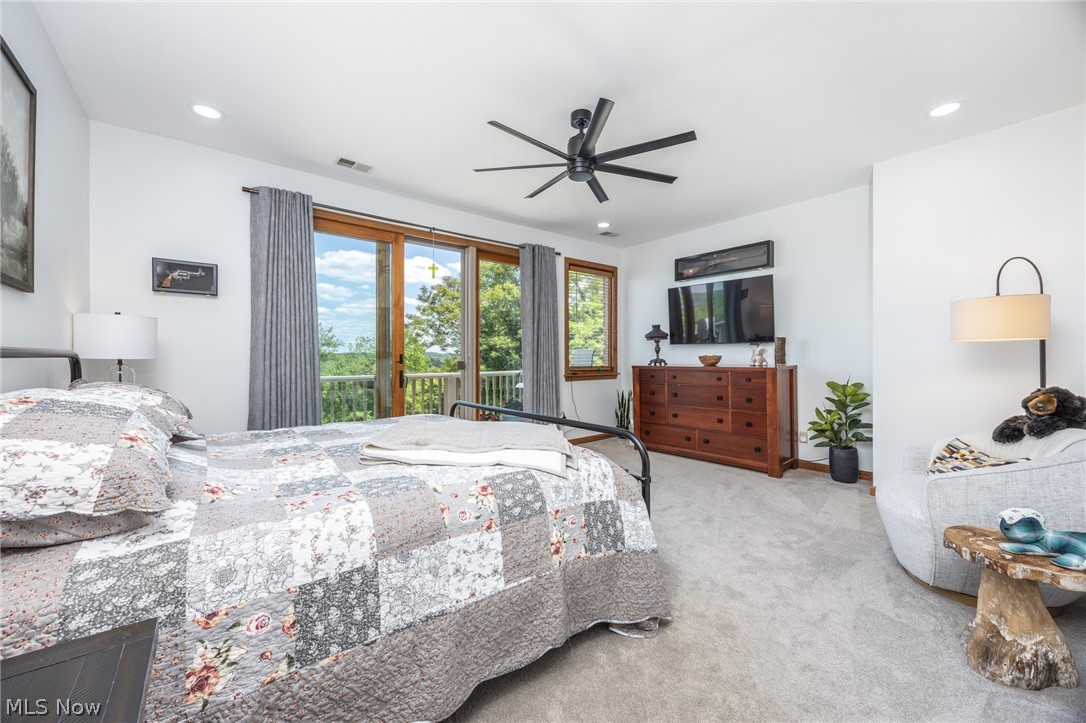 1602 Glendale Road, Unit 3 Marietta, OH 45750 - Photo 17 of 49 Bright bedroom featuring a large sliding glass door opening to a private balcony, a ceiling fan with integrated lighting, recessed lighting, and soft carpet flooring