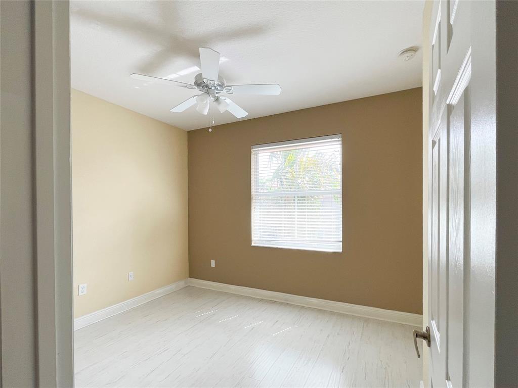 291 Lake Monterey Circle Boynton Beach, FL 33426 - Photo 33 of 47 an empty room with windows and fan