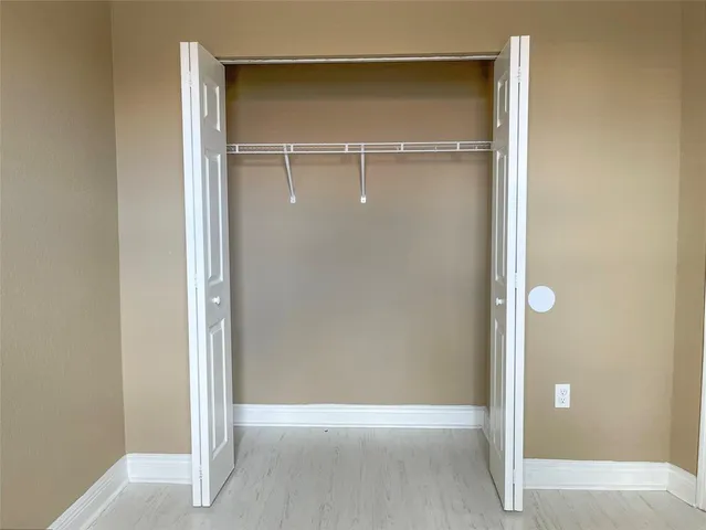 an empty room with a ceiling fan and carpet