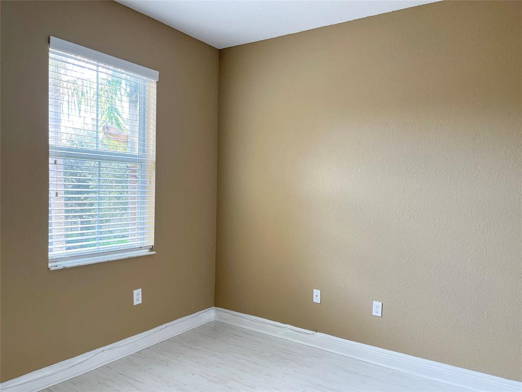 291 Lake Monterey Circle Boynton Beach, FL 33426 - Photo 40 of 47 a view of an empty room with wooden floor and a window