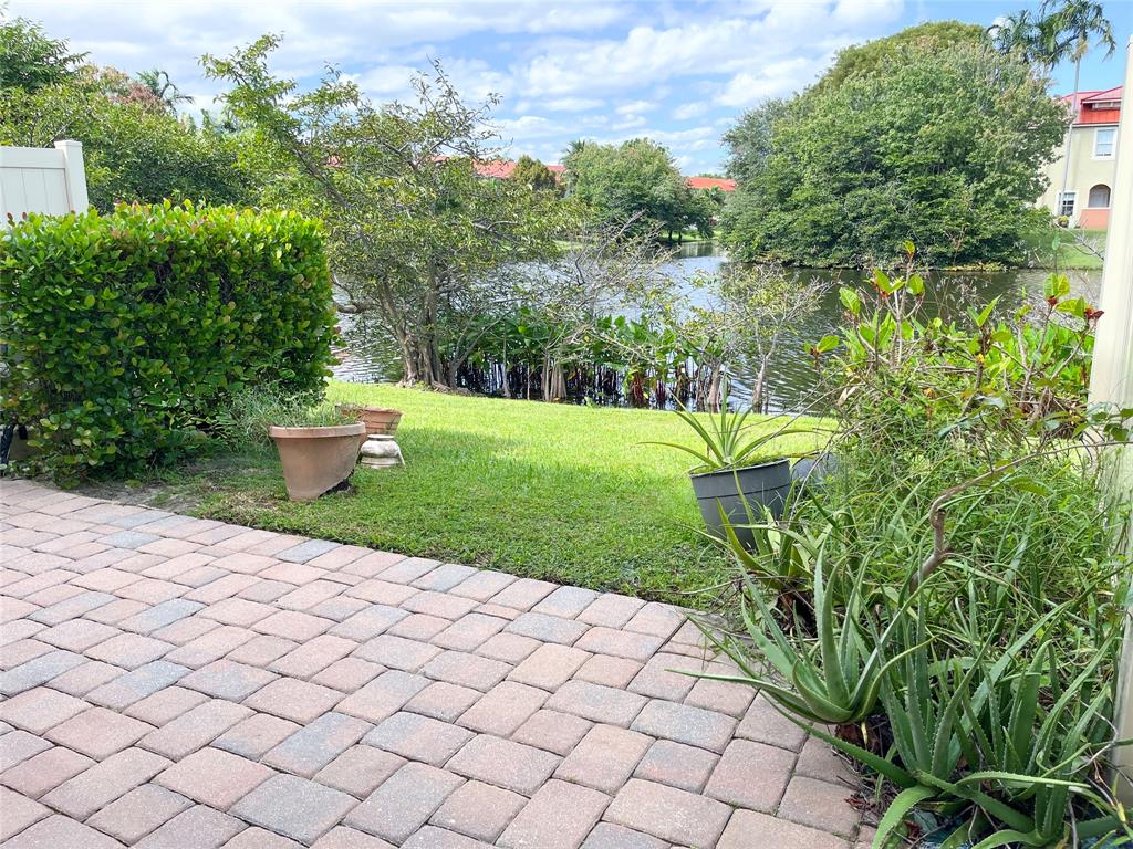 291 Lake Monterey Circle Boynton Beach, FL 33426 - Photo 44 of 47 a view of a garden with a flower garden