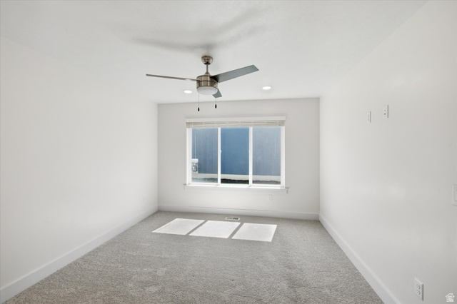 730 West 500 North Smithfield, UT 84335 - Photo 20 of 46 Room featuring neutral tone carpeting, white painted walls, a window with blinds, and an overhead ceiling fan with integrated lighting