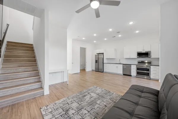 a living room with furniture and kitchen view