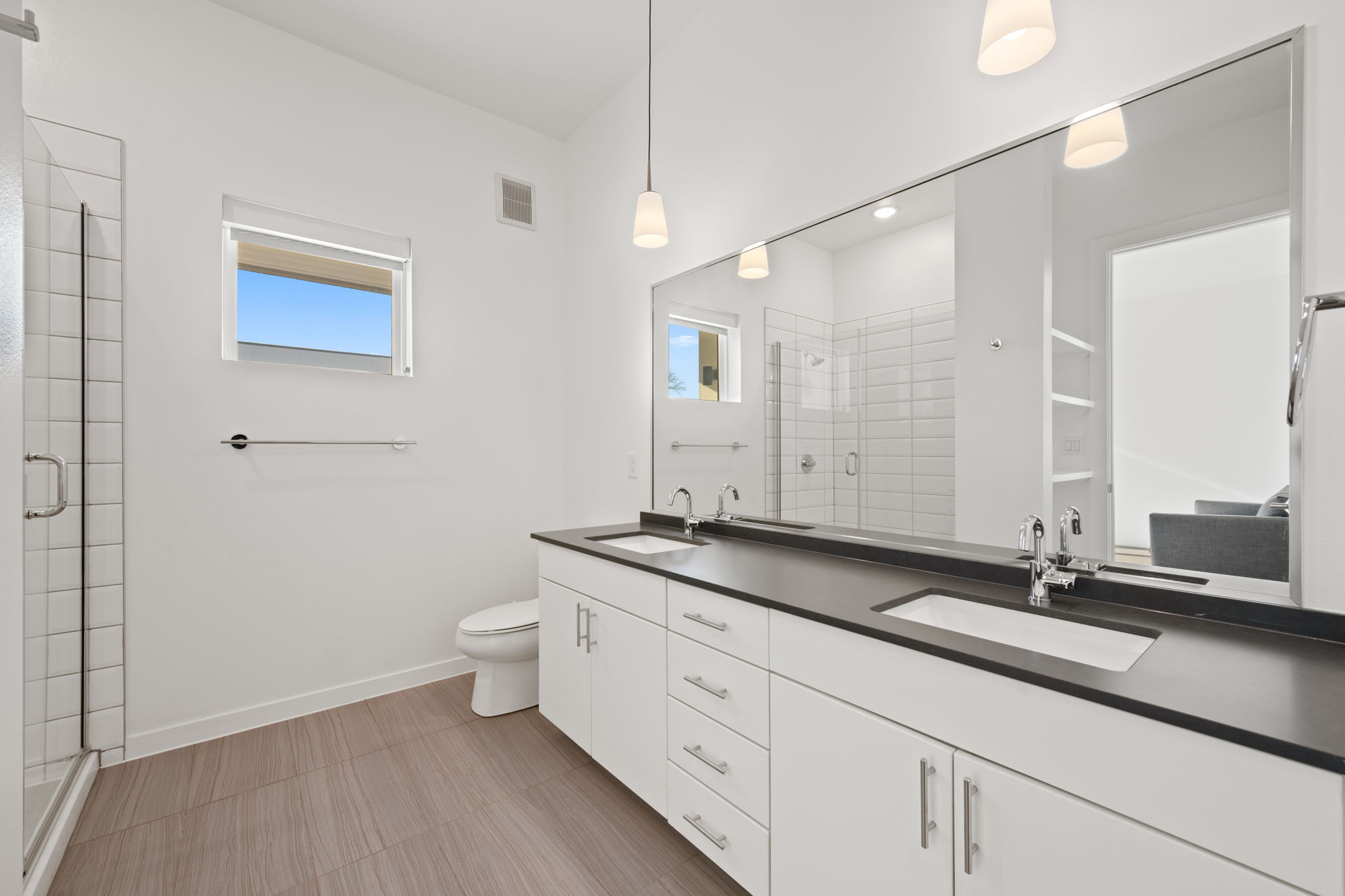 4901 Springdale Road, Unit 106 Austin, TX 78723 - Photo 18 of 40 a bathroom with a granite countertop sink a toilet and a mirror