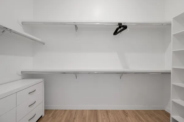 a view of cabinets with racks on the wall