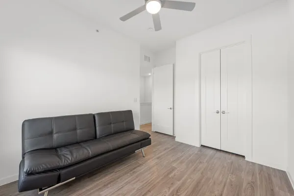 a living room with furniture and a ceiling fan