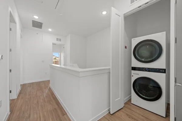 a view of a hallway with washer and dryer