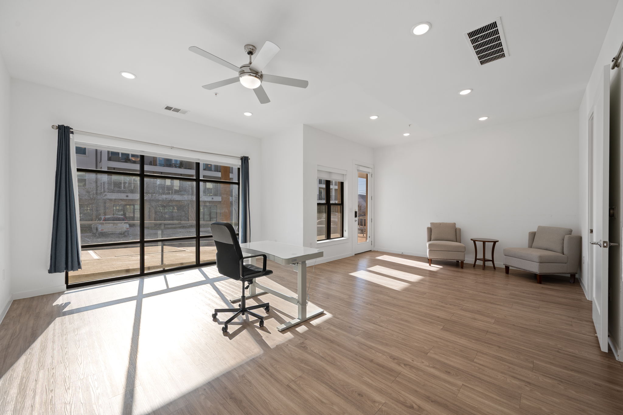 4901 Springdale Road, Unit 106 Austin, TX 78723 - Photo 4 of 40 a room with furniture and a wooden floor