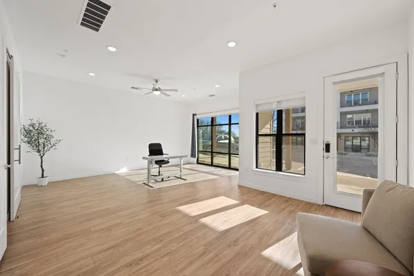 a living room with furniture and large window