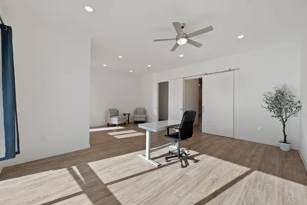 a workspace with wooden floor and a potted plant