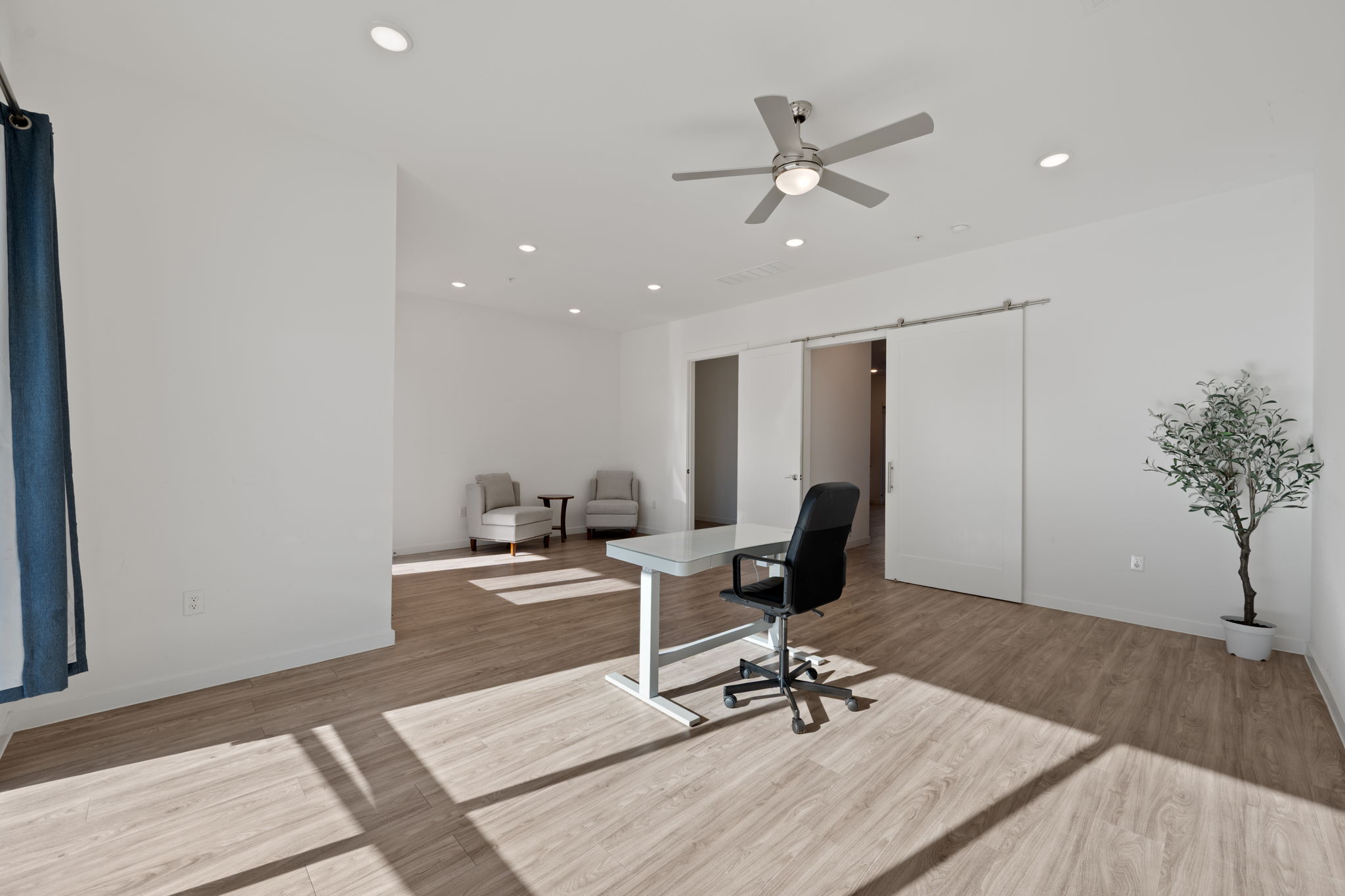 4901 Springdale Road, Unit 106 Austin, TX 78723 - Photo 7 of 40 a workspace with wooden floor and a potted plant