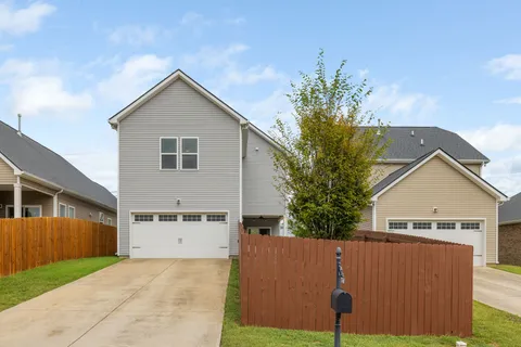 a living room with furniture and a baby crib
