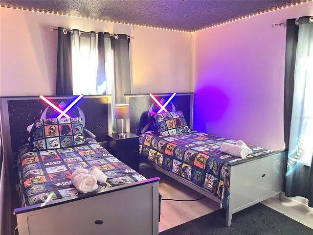 a bedroom with three beds and window