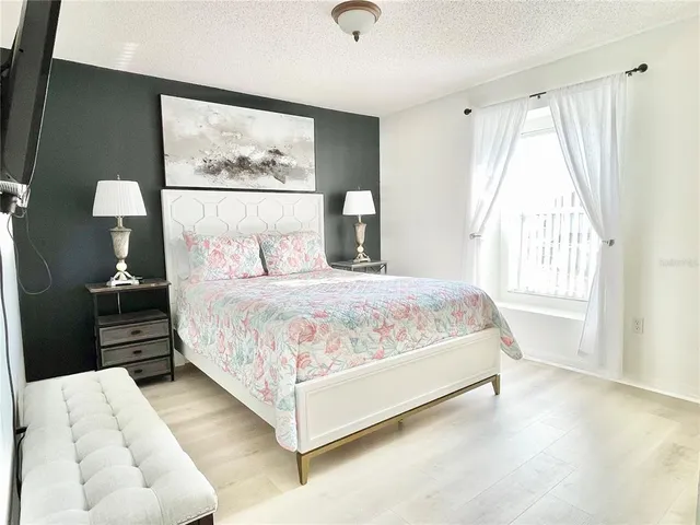 a bedroom with a bed and a large window