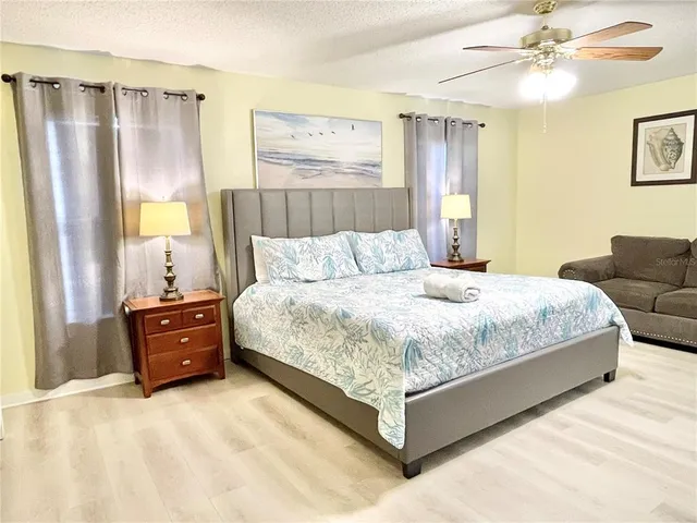 a bedroom with a bed and a chandelier