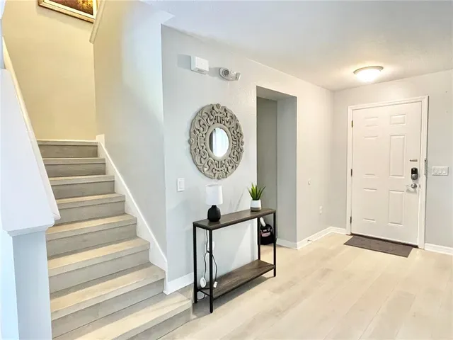 a view of a hallway with entryway wooden floor and front door