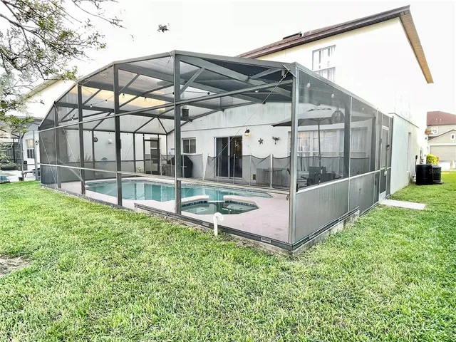 a view of a house with a backyard