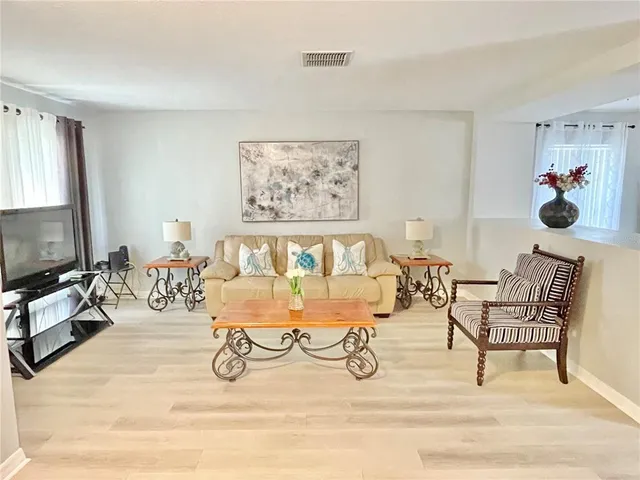 a view of a livingroom with furniture and a flat screen tv