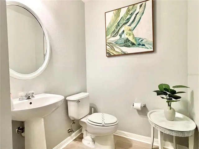 a bathroom with a toilet a sink and a mirror