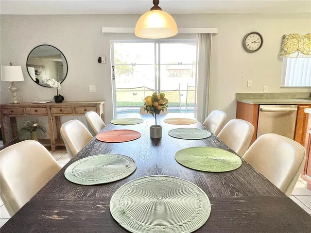 a view of a dining room with furniture and chandelier