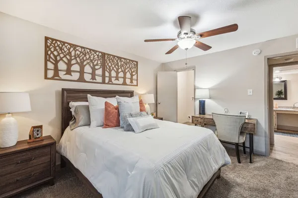 a bedroom with a bed and a chandelier