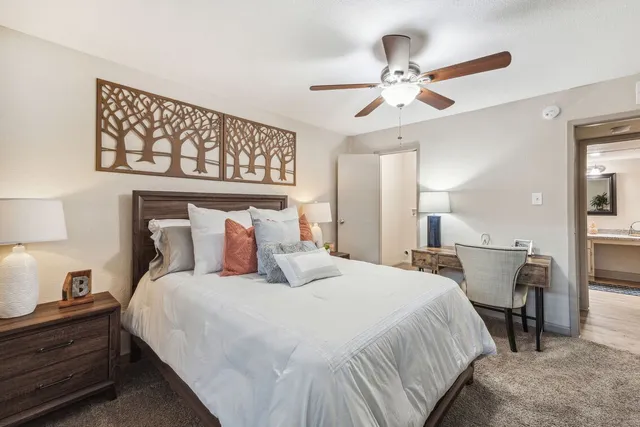 a bedroom with a bed and a chandelier