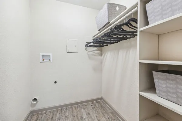 a view of walk in closet with clothes