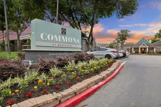 a sign that is sitting in front of flowers