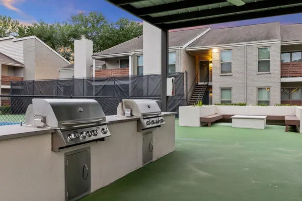 a view of a patio with table and chairs a barbeque