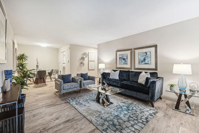 a living room with furniture and wooden floor