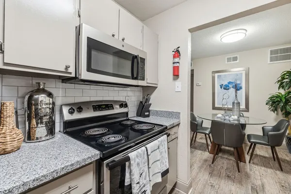 a kitchen with a stove and a microwave