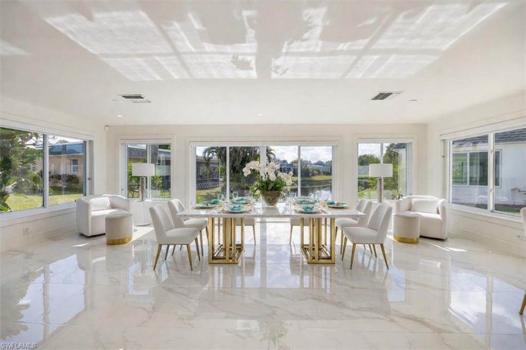 16 Knights Bridge Road Naples, FL 34112 - Photo 2 of 18 Sunroom with healthy amount of natural light and a water view