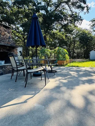 a view of a swimming pool with a lounge chair and a fire pit