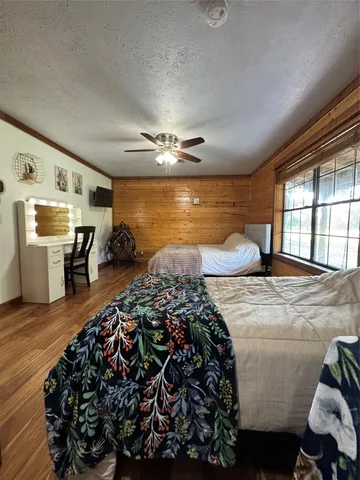 a bedroom with furniture and a large window