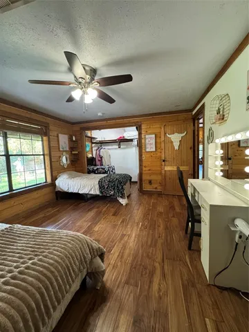 a bedroom with bed and a chandelier