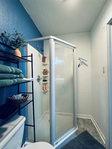 a bathroom with a glass shower door