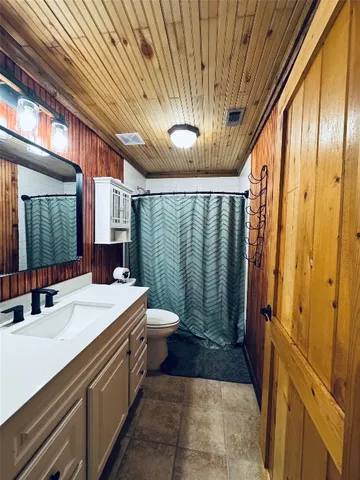 a bedroom with furniture and a flat screen tv