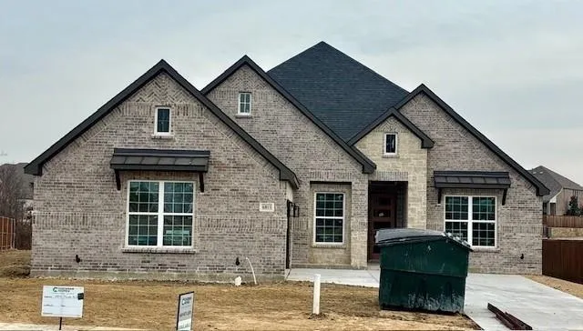 a front view of a house with outdoor seating
