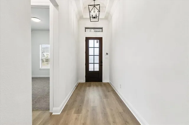 a view of a hallway to rooms