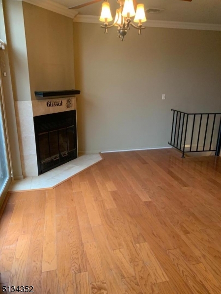 33 Diamond Spring Road, Unit 1C Denville, NJ 07834 - Photo 3 of 8 a view of empty room with a fireplace