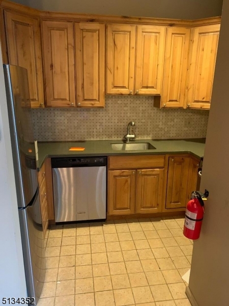 33 Diamond Spring Road, Unit 1C Denville, NJ 07834 - Photo 4 of 8 a bathroom with a sink a toilet and a shower