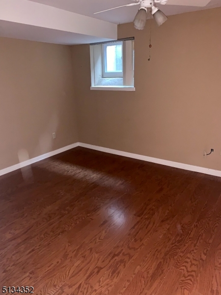 33 Diamond Spring Road, Unit 1C Denville, NJ 07834 - Photo 5 of 8 a view of an empty room with wooden floor and a window